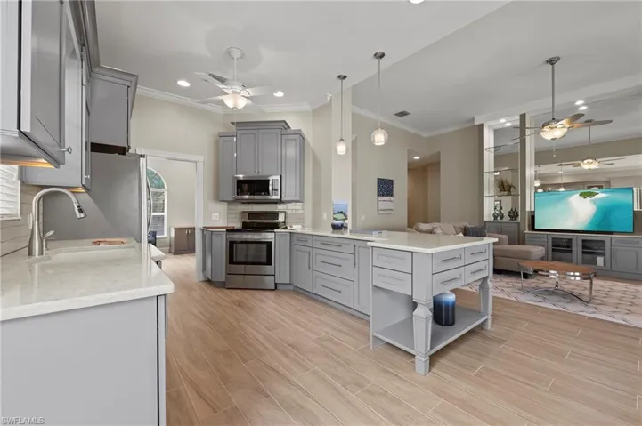 15402 Trevally Way Bonita Springs FL 34135 - New kitchen with staggered cabinets, drawers for easily accessible storage.