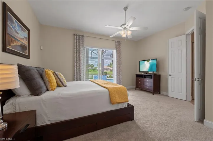 15402 Trevally Way Bonita Springs FL 34135 - Owner's bedroom with double door entry and view of the lake