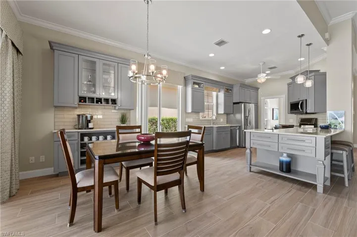 15402 Trevally Way Bonita Springs FL 34135 - Dining and kitchen area with updated lighting fixtures