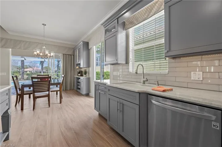 15402 Trevally Way Bonita Springs FL 34135 - Light colored tile backsplash with shaker style cabinets.