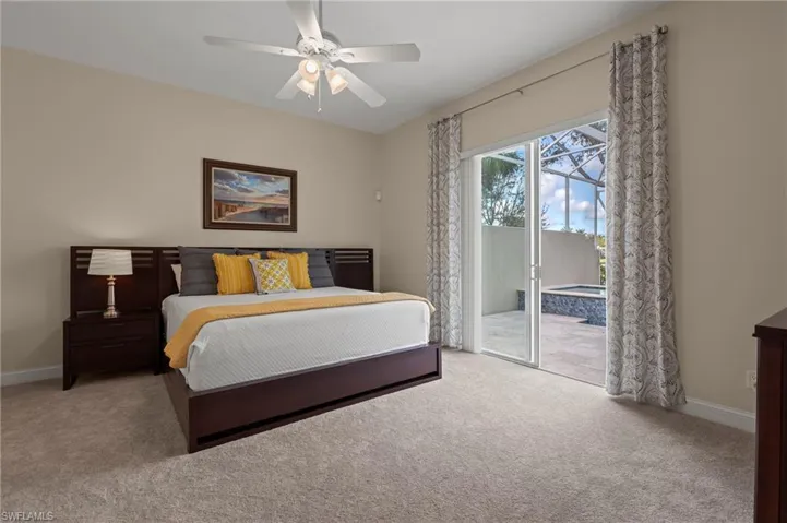 15402 Trevally Way Bonita Springs FL 34135 - Owner's bedroom with impact slider access to pool deck