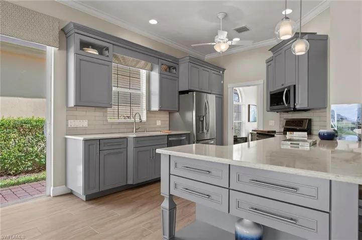 15402 Trevally Way Bonita Springs FL 34135 - New kitchen with glass front lit top cabinets.