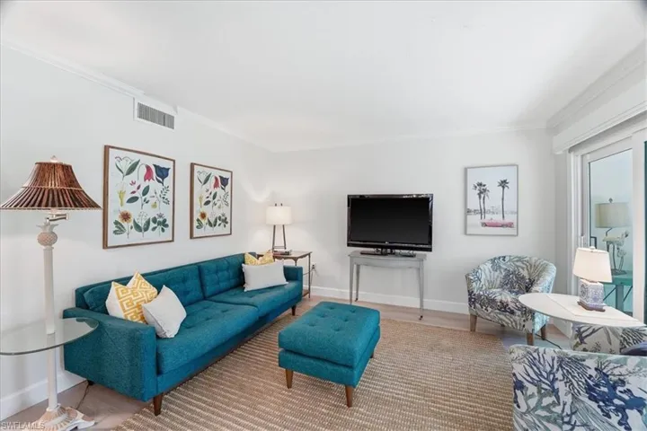 Living room featuring crown molding and wood finished floors