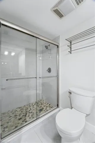 Full bathroom with tile patterned flooring and a stall shower