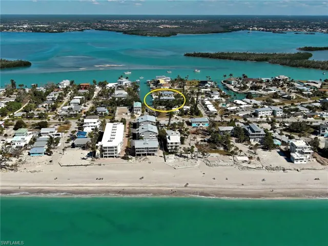 Aerial view of residential area featuring expansive coastline