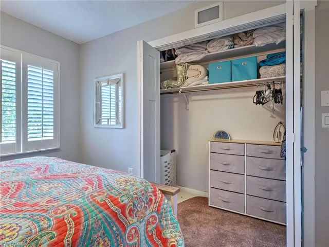 Bedroom with dark colored carpet