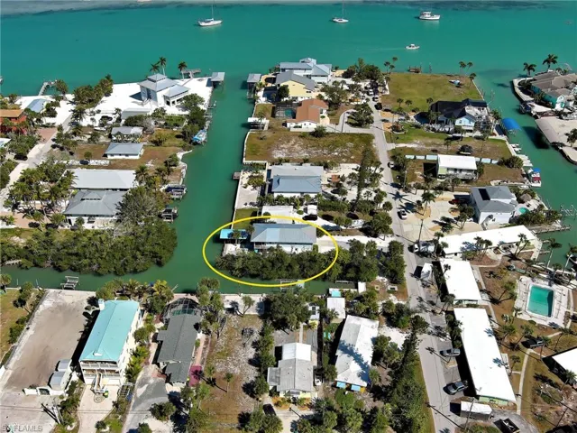Aerial overview of property's location featuring nearby suburban area and a nearby body of water