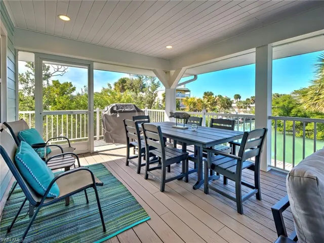 Deck with outdoor dining area and a grill
