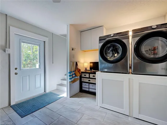 Laundry room featuring cabinet space and separate washer and dryer