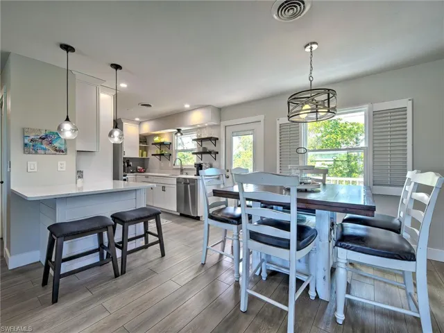 Dining room featuring light wood finished floors and hanging lights
