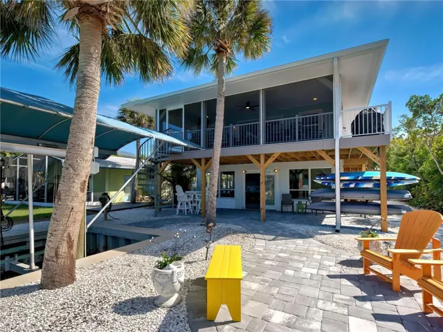Back of house with a patio, a deck, outdoor dining area, and ceiling fan