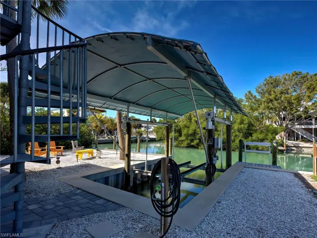 Dock area with boat lift and a water view