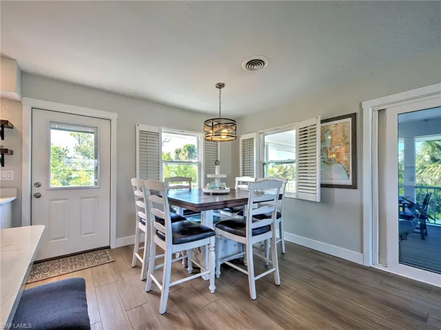 Dining area with light wood-style floors and plenty of natural light