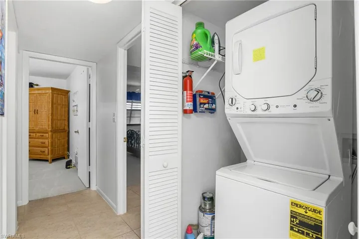 Laundry area featuring stacked washer / dryer.