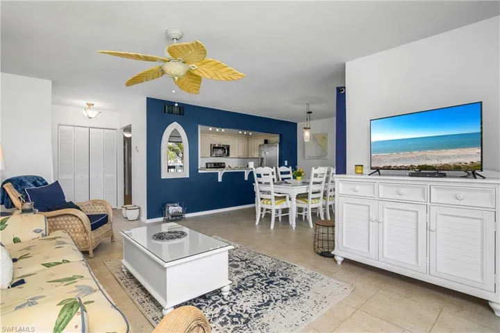 Tiled living room with ceiling fan.