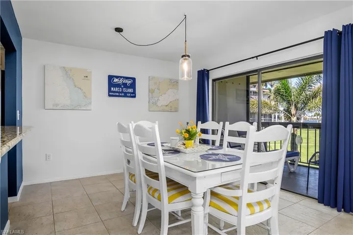 Dining space with light tile patterned flooring.