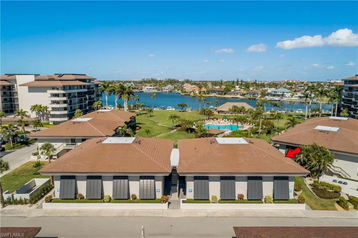 End Unit. Birds eye view of property with a water view.