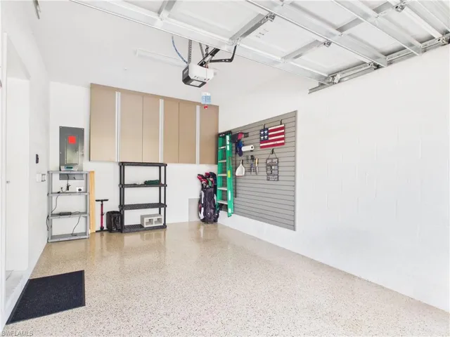 Garage with electric panel and a garage door opener