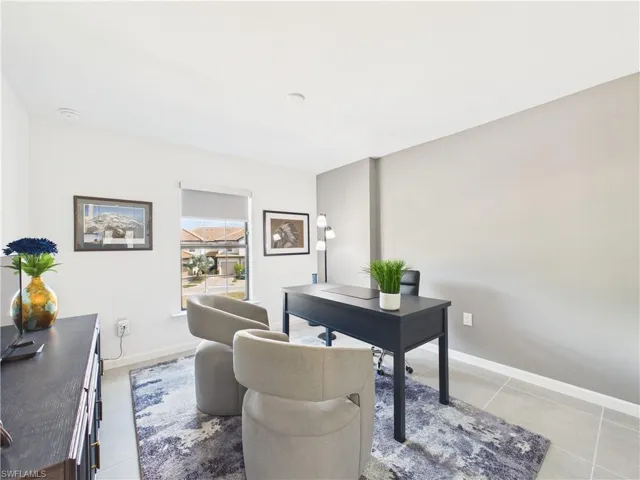 Office area with baseboards and light tile patterned floors