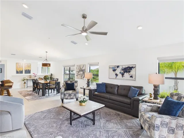 Tiled living area featuring ceiling fan and recessed lighting