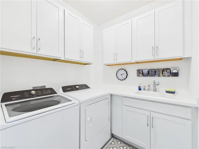 Laundry room with independent washer and dryer and cabinet space