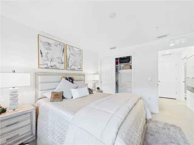 Bedroom with a closet and light tile patterned floors