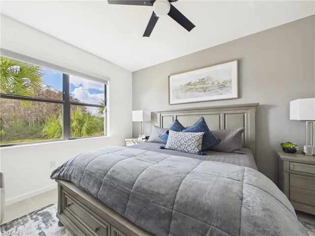 Bedroom with a ceiling fan and baseboards