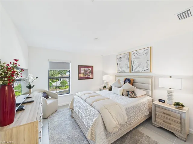 Bedroom with baseboards and light tile patterned floors
