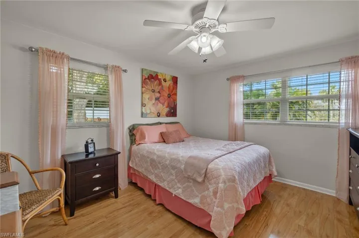 Bedroom with ceiling fan and light hardwood / wood-style floors