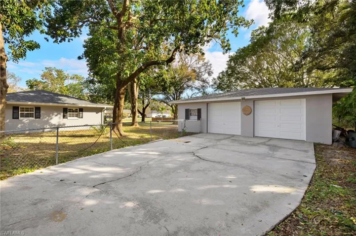 Garage featuring a lawn