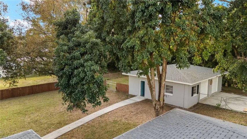 Obstructed view of property with a front lawn