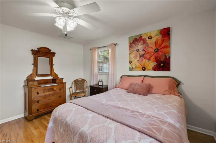 Bedroom with ceiling fan and light wood-type flooring