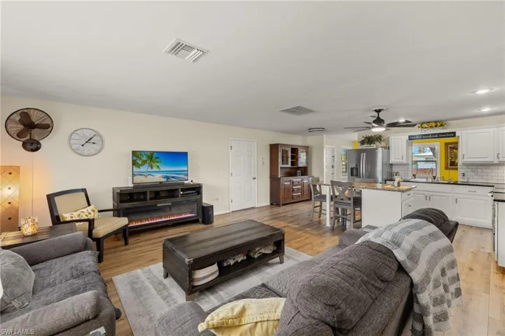 Living room featuring ceiling fan and light hardwood / wood-style flooring