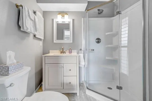 Full bathroom with a stall shower and vanity