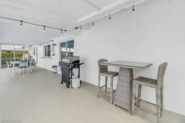 View of patio featuring outdoor dining area and a grill