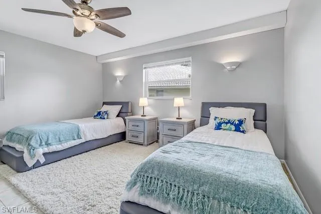Bedroom featuring ceiling fan and baseboards