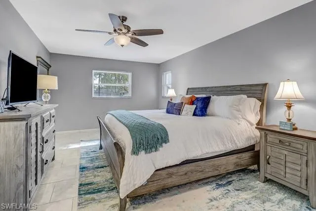 Bedroom featuring a ceiling fan and light tile patterned flooring
