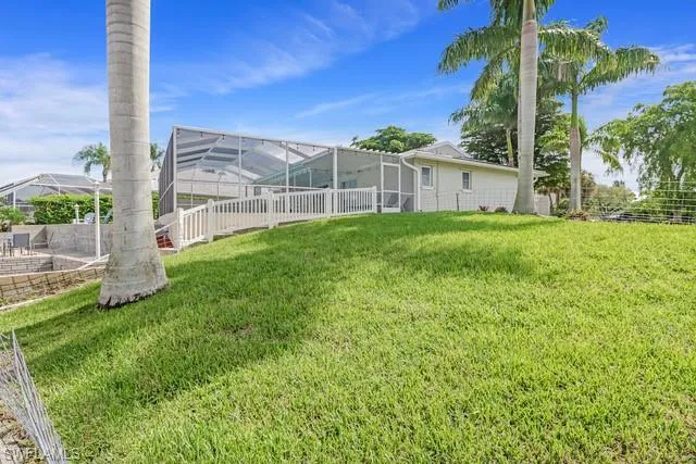 View of yard featuring a sunroom and a lanai