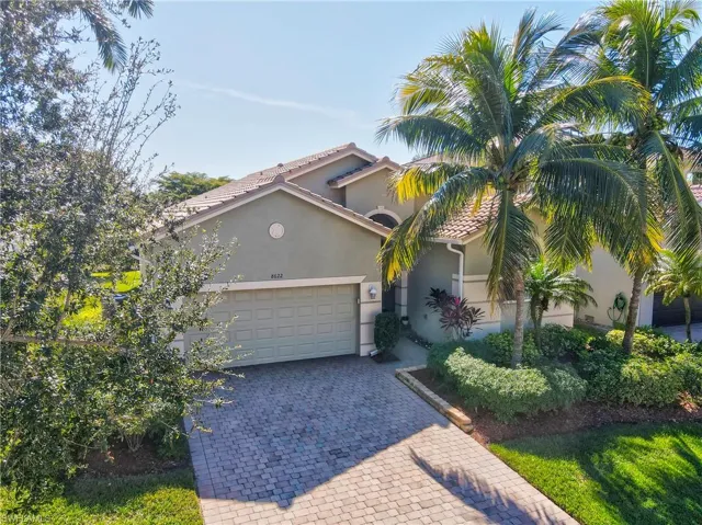 Mediterranean / spanish house with stucco siding, decorative driveway, a garage, and a tiled roof