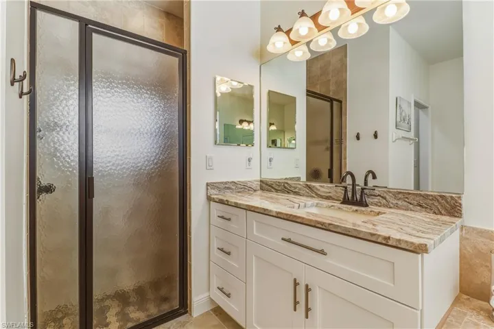 Full bathroom featuring a stall shower and vanity