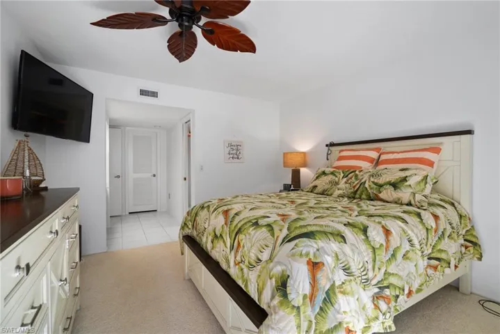 Bedroom with light carpet and ceiling fan