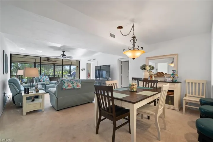 Carpeted dining area with ceiling fan