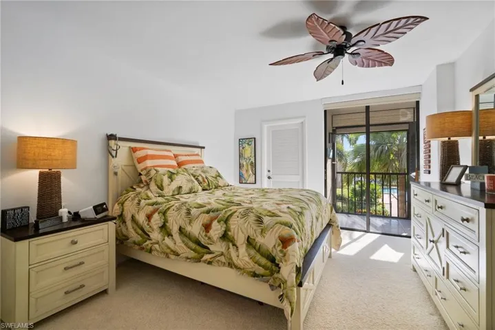Bedroom with light carpet, access to exterior, and ceiling fan