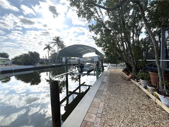 COVERED BOAT DOCK W/EXTRA WIDE APPROX.  12K LIFT.  ZEROSCAPE LANDSCAPING.