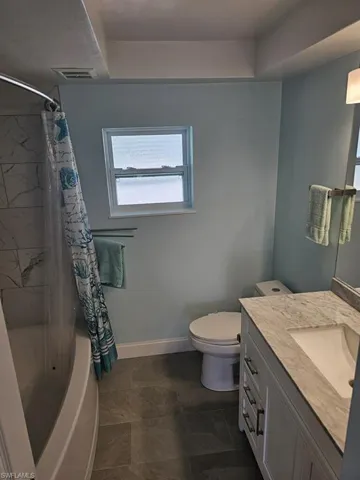 GUEST BATH.  GRANITE TOPPED VANITY W/UNDERMOUNT SINK.  TILED SHOWER WALLS.