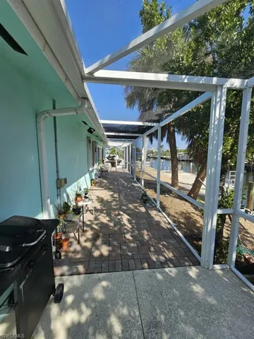 VIEW FROM POOL AREA INTO SCREENED LANAI AREA
