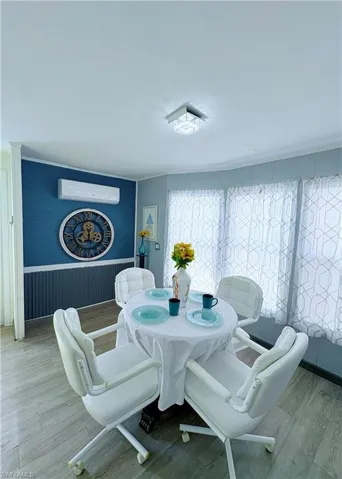 Dining room with wood finished floors and wainscoting