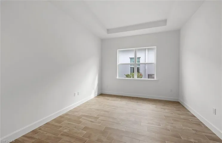 Unfurnished room with a raised ceiling