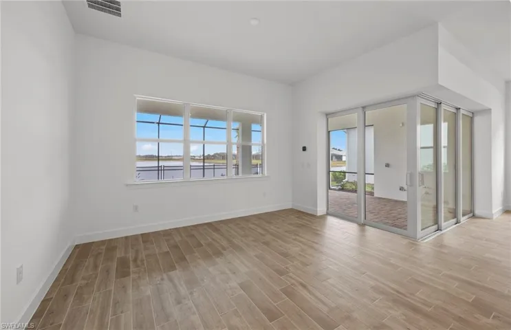 Unfurnished room featuring a water view and light wood-type flooring