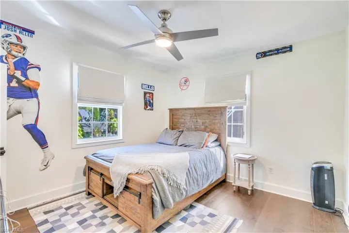 Bedroom featuring ceiling fan and hardwood / wood-style floors
